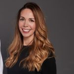 Bernadette Wilson - a white lady with long blond hair in a black top smiling at the camera