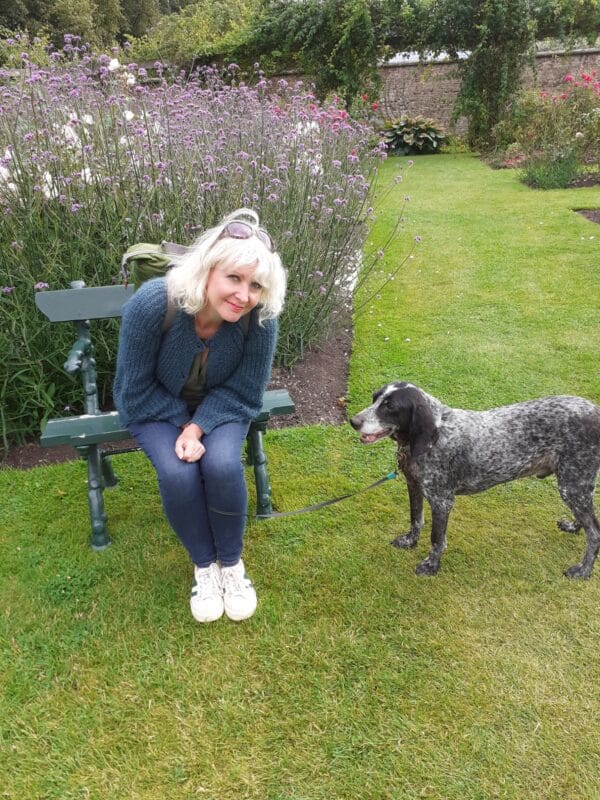 Diagnosis later in life: My ADHD journey - Photo of Nina Byrne sitting on a bench in a park with her dog.