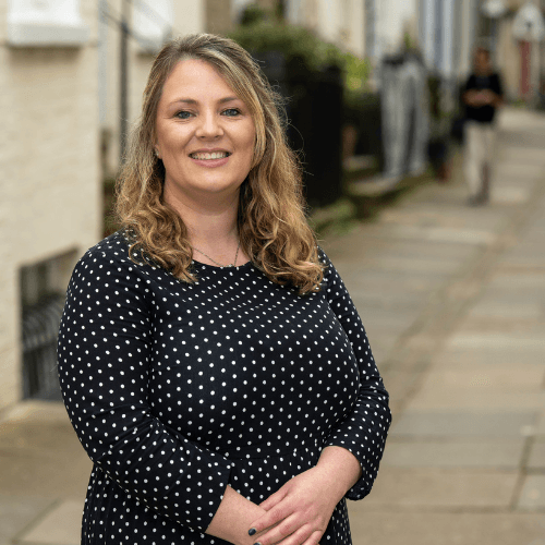 Gemma - a blond lady with mid-length hair in a blue spotty dress