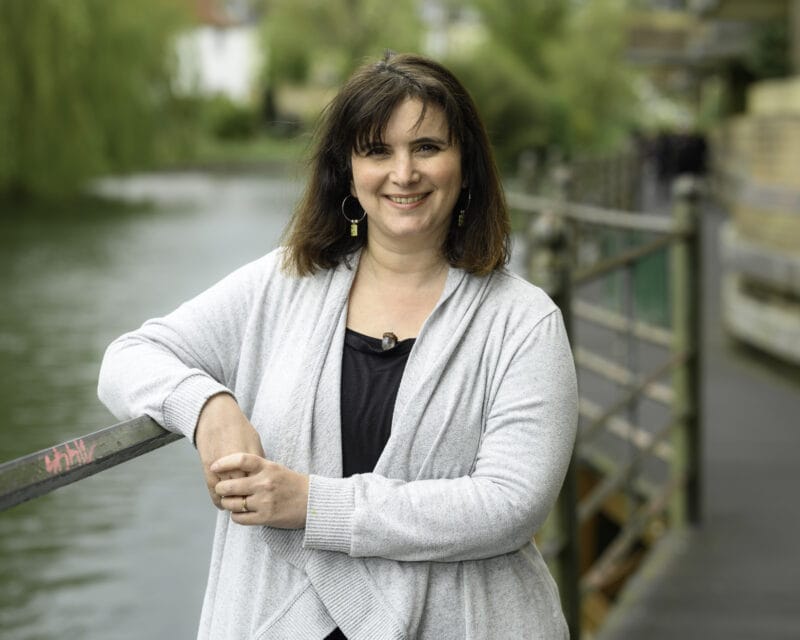 Dr Deborah Leveroy, a lady with short black hair wearing a grey waterfall cardigan.