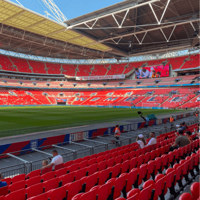 Inside of Wembley Stadium- chairs are red and have Wembley painted on them