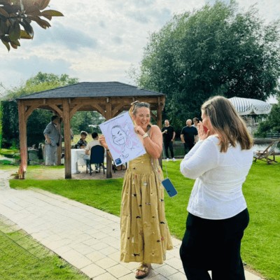 Asian Female, taking picture with her caricature