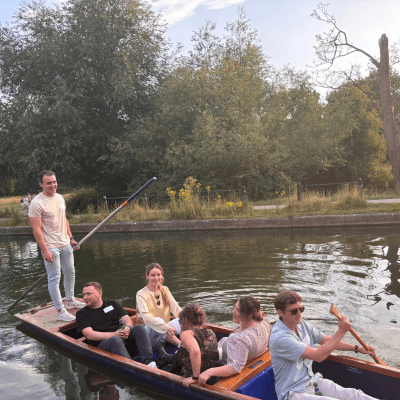 six staff members, male and female, on a punt