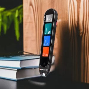 A scanmarker pro on top of a desk next to some hardcover books