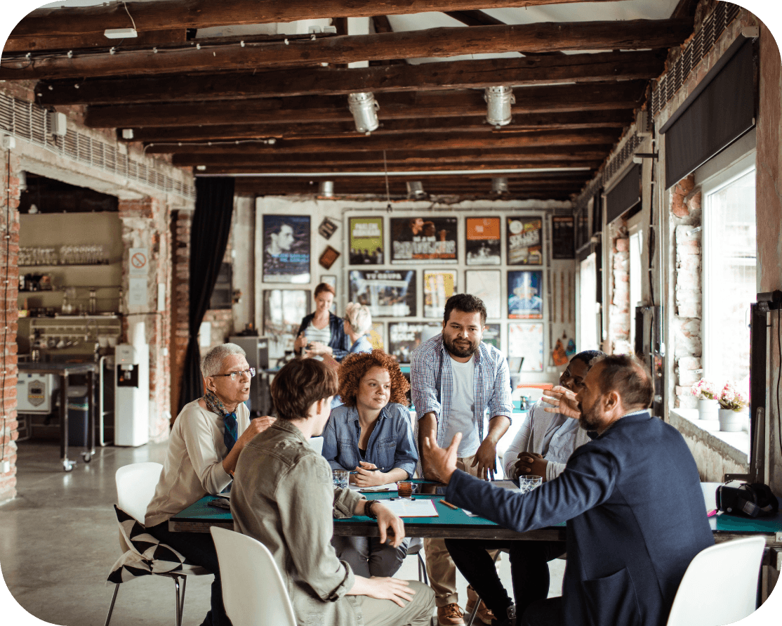 a group of males and females working together in an open office space