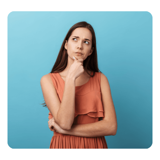 Brunette woman, wearing an orange dress looking deep in thought