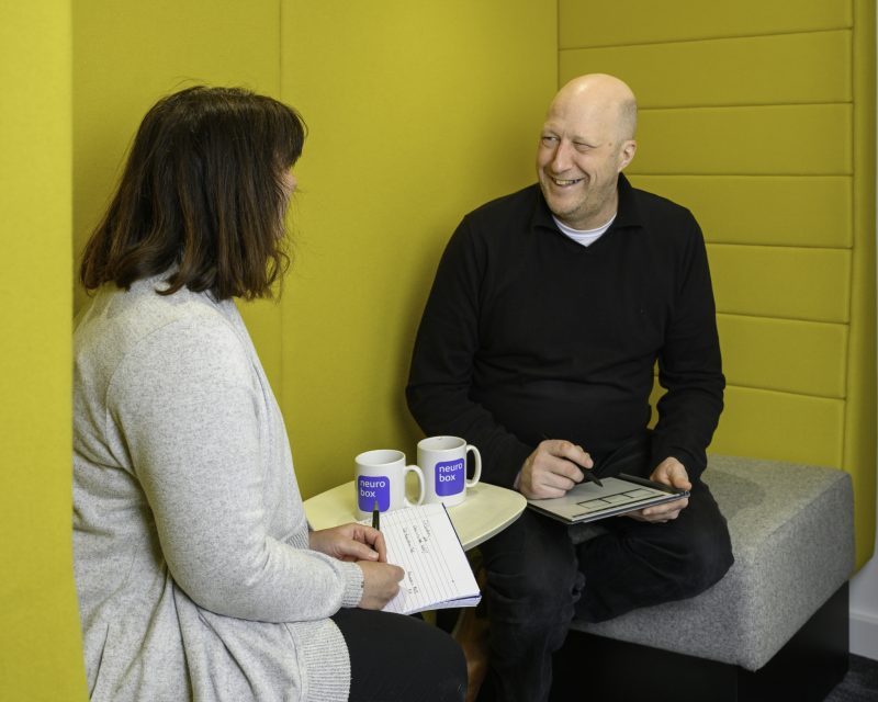 two people talking in a yellow soundproof office